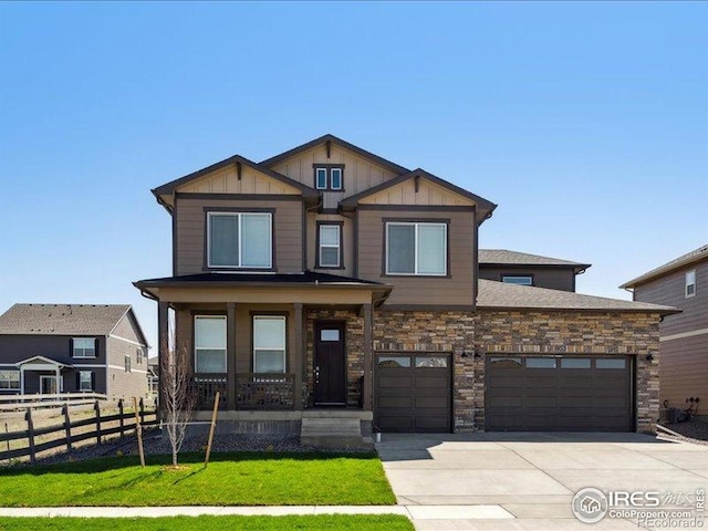craftsman inspired home featuring driveway, covered porch, an attached garage, and board and batten siding