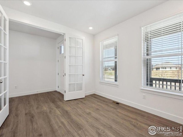 unfurnished room featuring french doors, baseboards, wood finished floors, and recessed lighting