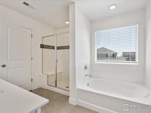 bathroom with a stall shower, a garden tub, tile patterned flooring, and recessed lighting