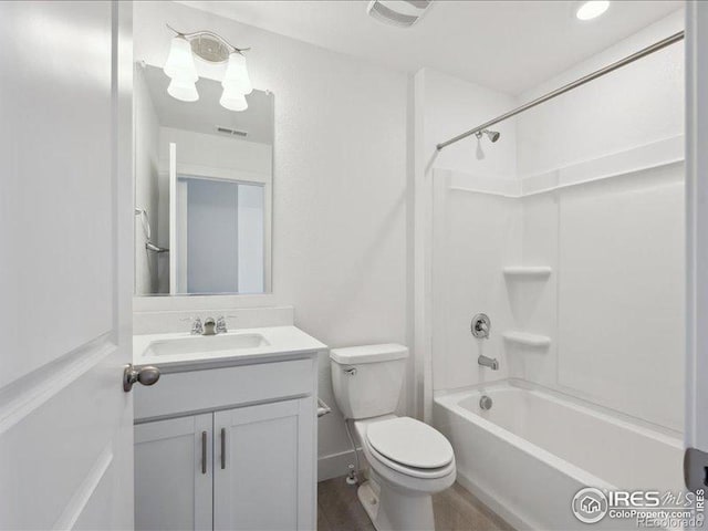 bathroom featuring vanity, toilet, washtub / shower combination, and wood finished floors
