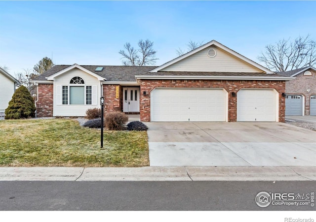 single story home with a garage and a front lawn