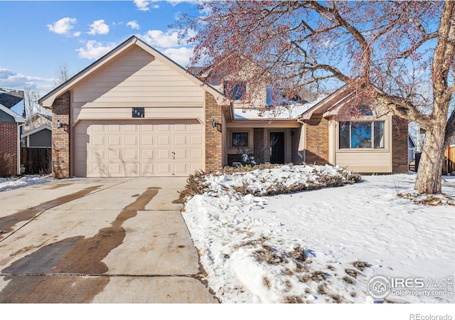 single story home with brick siding, concrete driveway, and an attached garage