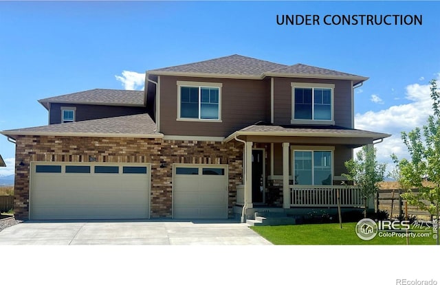 view of front of property with a porch and a garage