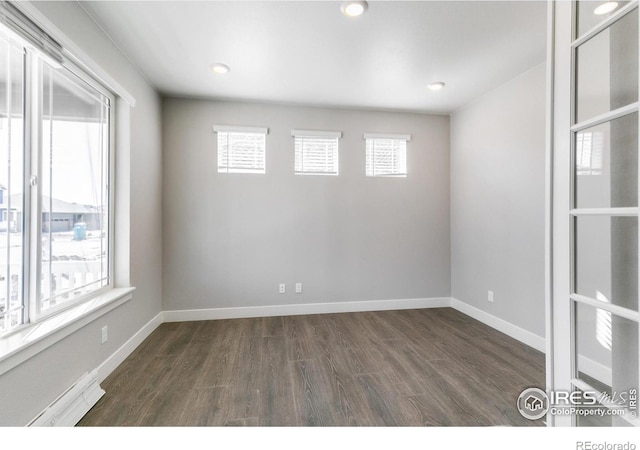 spare room featuring dark wood-type flooring