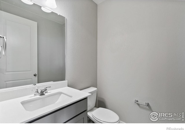 bathroom featuring vanity and toilet