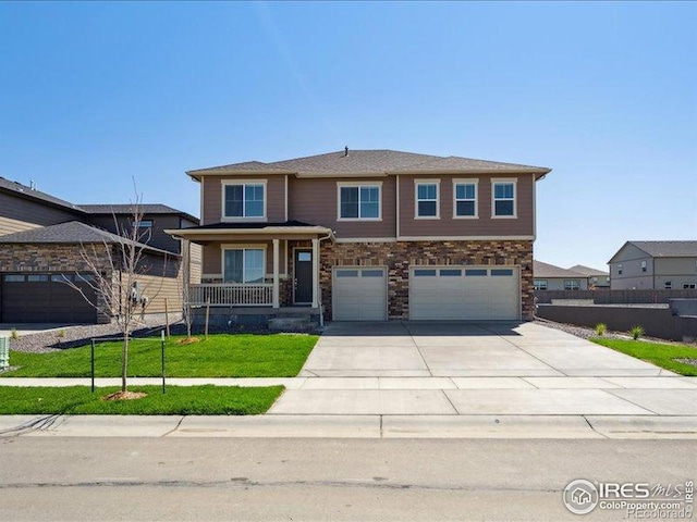 view of front facade featuring an attached garage, concrete driveway, stone siding, and a porch