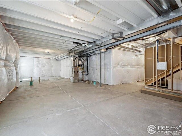 unfinished below grade area featuring heating unit