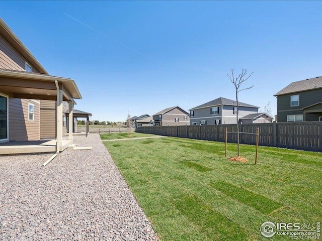 view of yard with a patio and a residential view