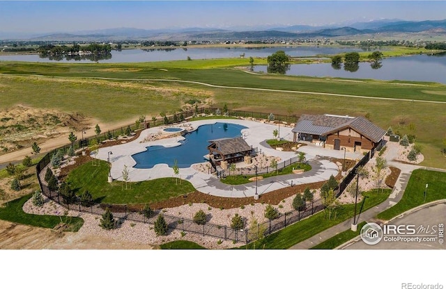 view from above of property with a large body of water and a pool