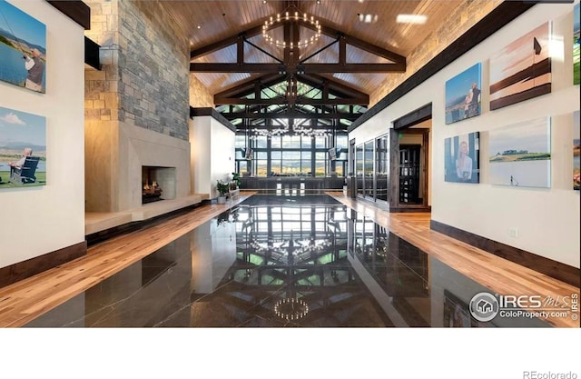 common area featuring high vaulted ceiling and wooden ceiling