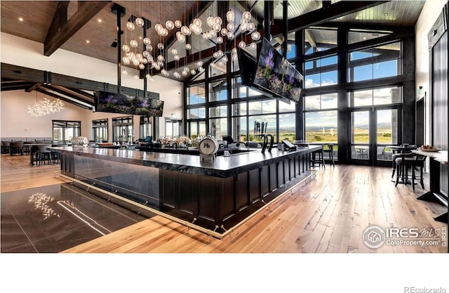 community lobby with high vaulted ceiling, wooden ceiling, and beam ceiling