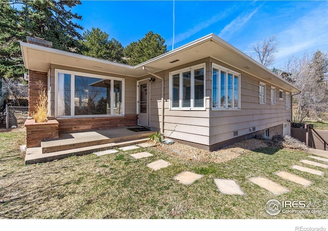 view of front of house featuring a patio area and a front yard