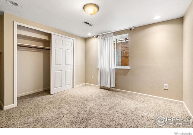 unfurnished bedroom with carpet flooring and a closet