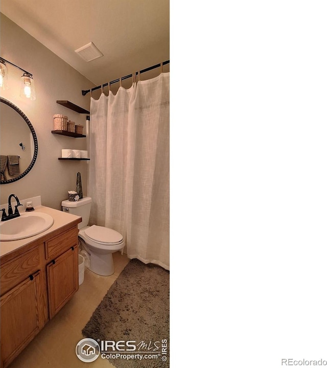 bathroom with walk in shower, vanity, and toilet