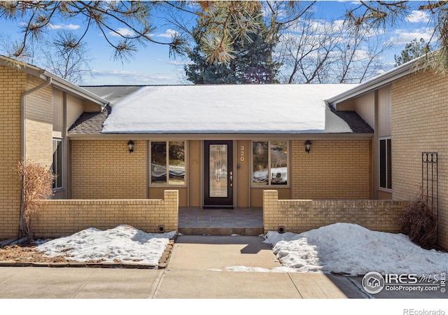 view of snow covered property entrance