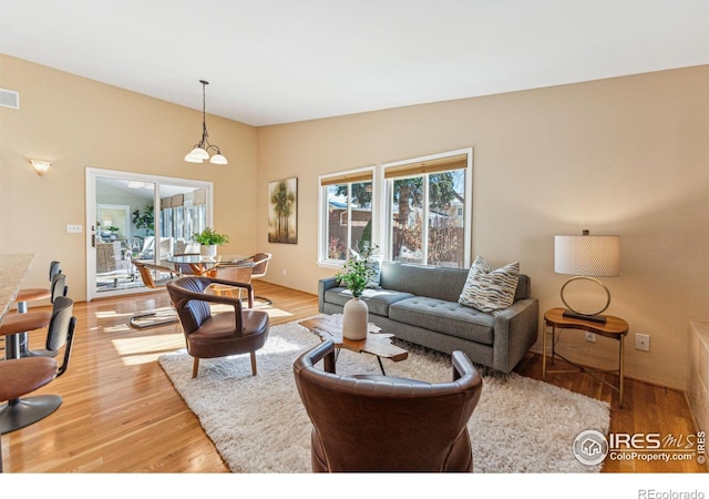 living room with hardwood / wood-style flooring and vaulted ceiling