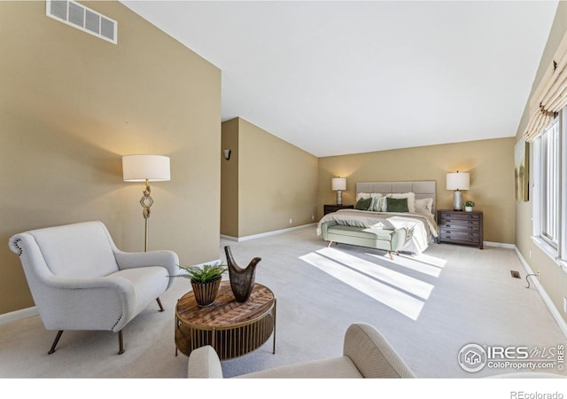 carpeted bedroom featuring lofted ceiling