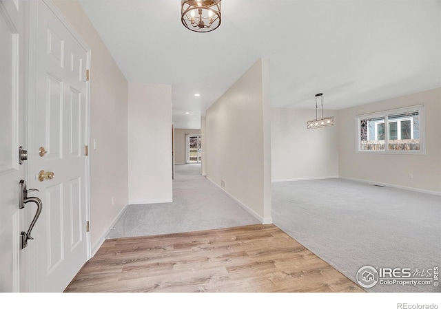 entrance foyer featuring light carpet