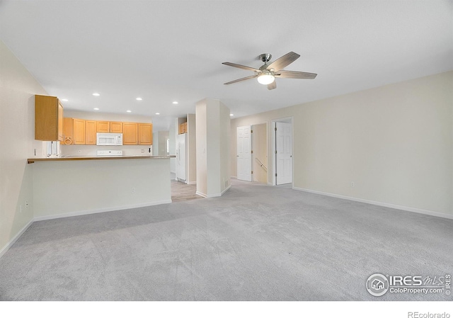 unfurnished living room featuring ceiling fan and light carpet