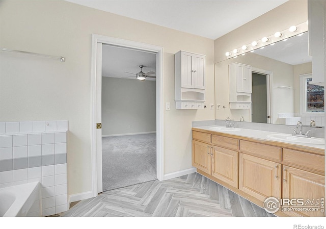 bathroom featuring vanity, parquet floors, a bathing tub, and ceiling fan