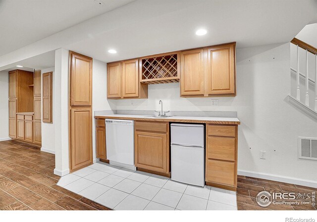 kitchen with dishwasher, fridge, and sink