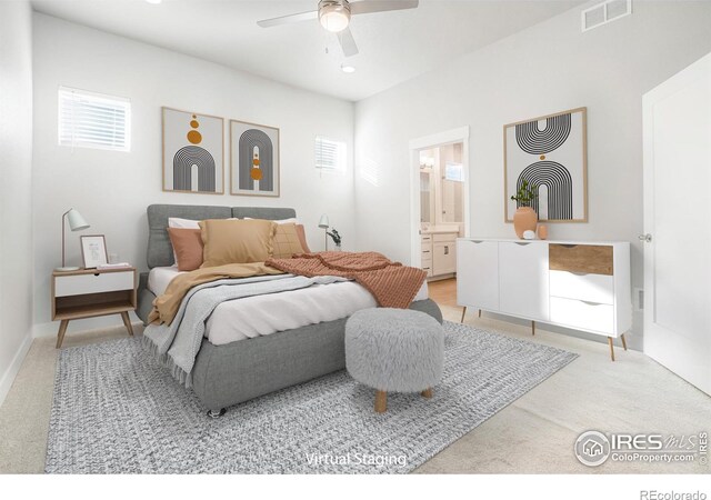 bedroom featuring a ceiling fan, visible vents, light carpet, and ensuite bath