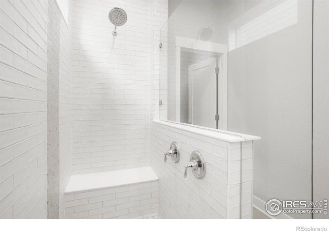 full bathroom with a tile shower