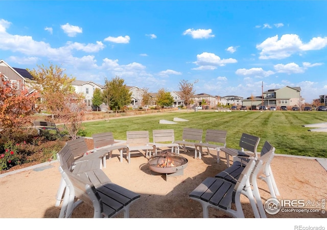 view of patio featuring a fire pit and a residential view