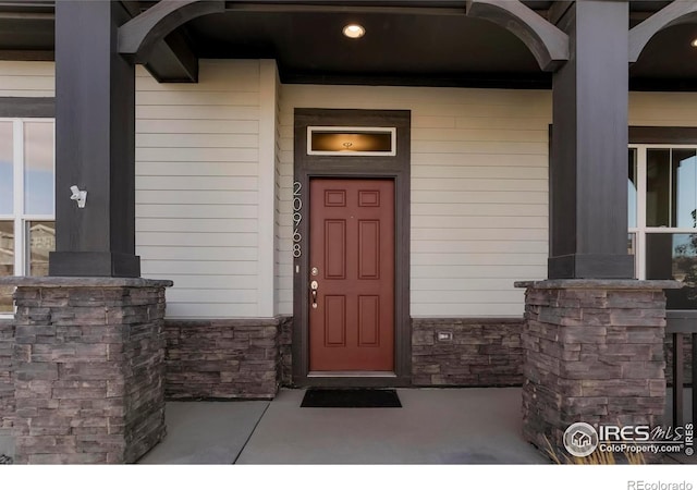 entrance to property featuring stone siding