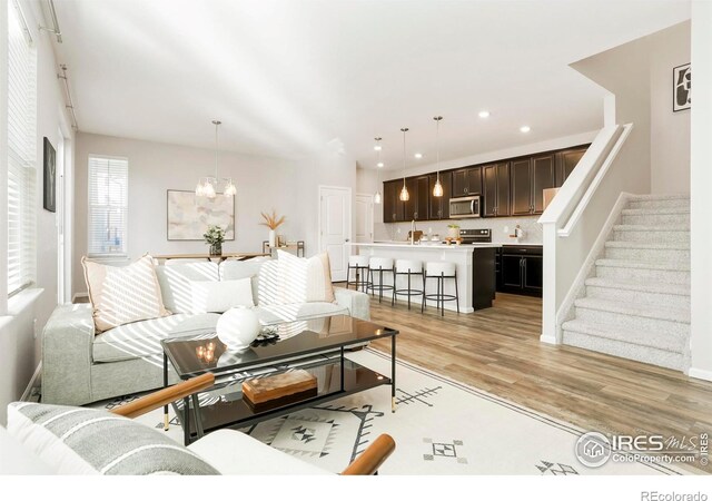 living room featuring light hardwood / wood-style floors and a chandelier