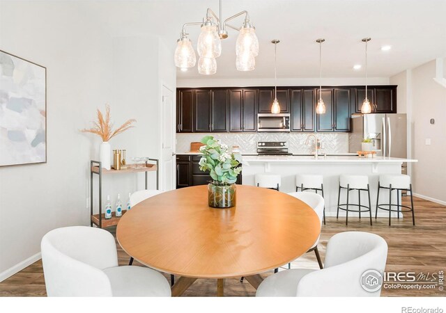 dining space with wood-type flooring