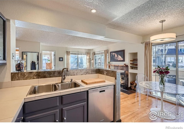 kitchen with sink, light hardwood / wood-style flooring, gray cabinets, dishwasher, and pendant lighting