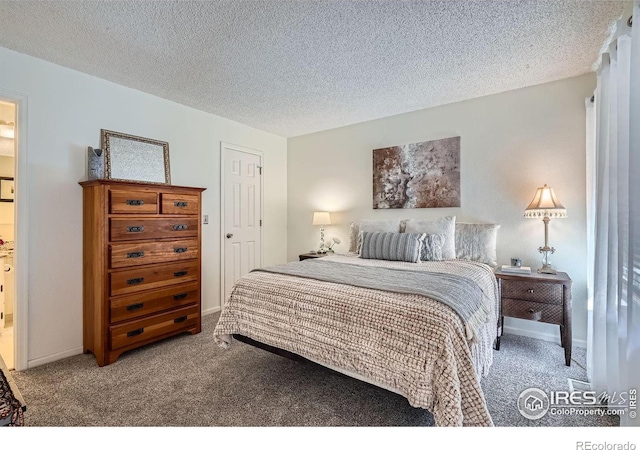 bedroom featuring carpet flooring and a textured ceiling