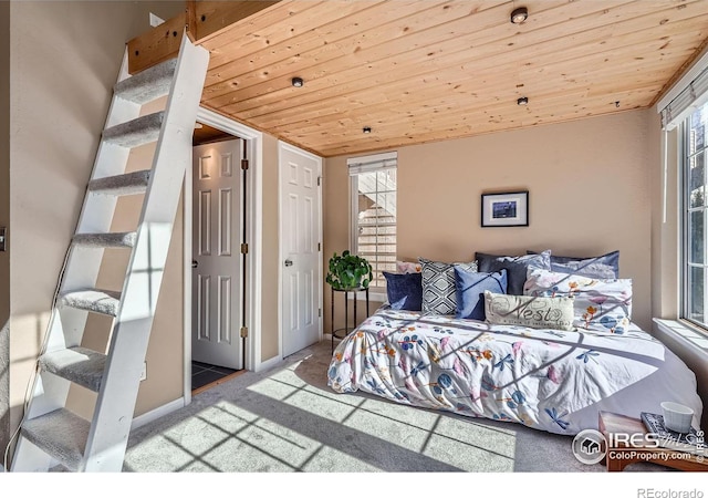 carpeted bedroom with wood ceiling