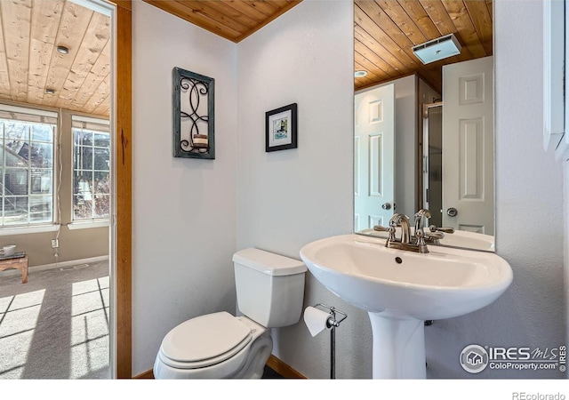 bathroom featuring sink, wood ceiling, and toilet