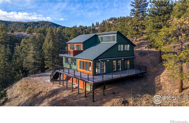 rear view of house featuring a deck