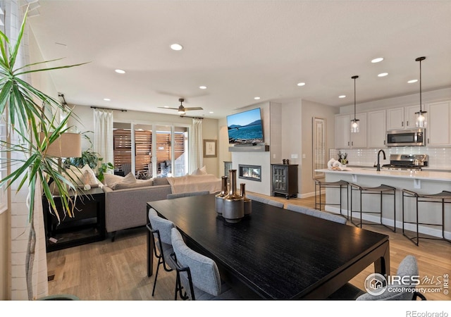 dining room featuring light hardwood / wood-style floors and ceiling fan