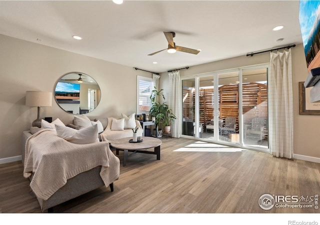 living room featuring hardwood / wood-style flooring and ceiling fan