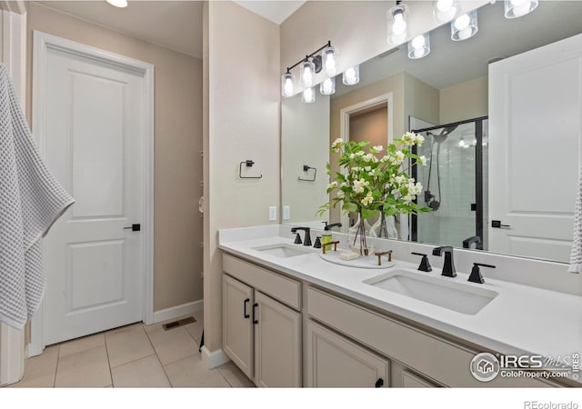 bathroom featuring vanity, tile patterned floors, and walk in shower