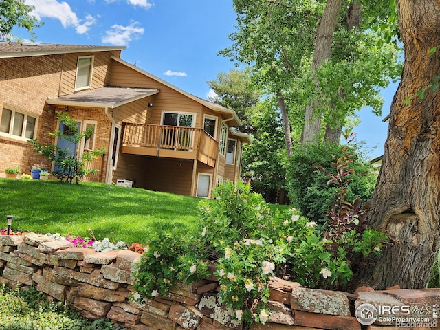 back of property with a deck and a lawn