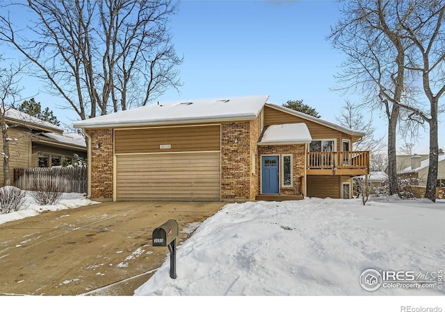 view of front facade with a garage and a deck