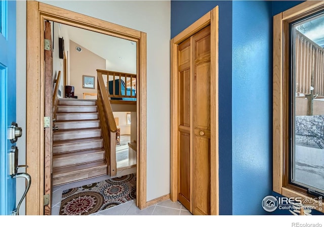 stairway featuring tile patterned flooring