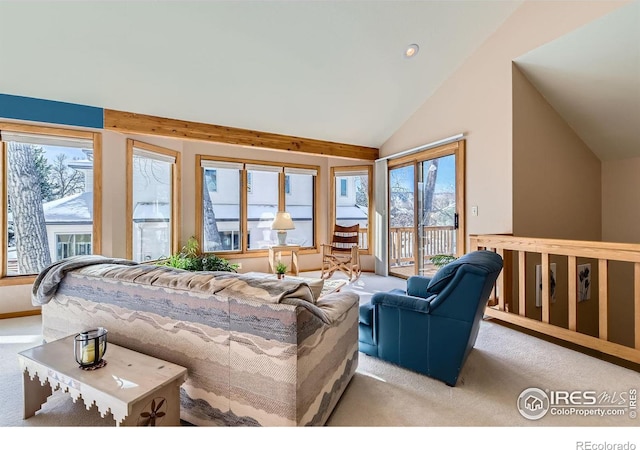 living room featuring a wealth of natural light, light colored carpet, and vaulted ceiling