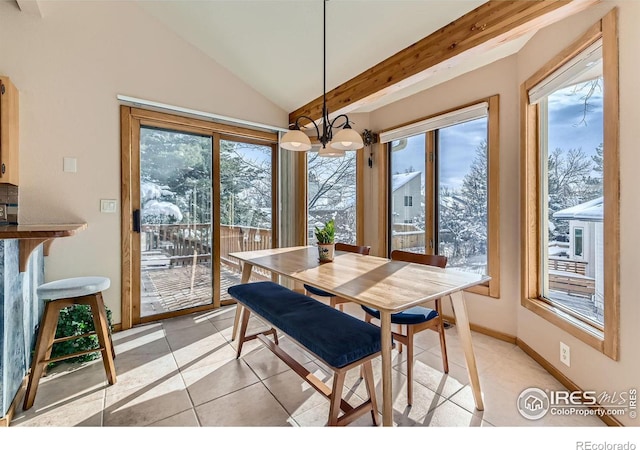 dining area featuring plenty of natural light, light tile patterned floors, lofted ceiling, and a chandelier