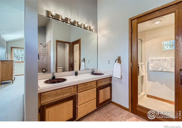 bathroom featuring vanity, lofted ceiling, tile patterned floors, and toilet