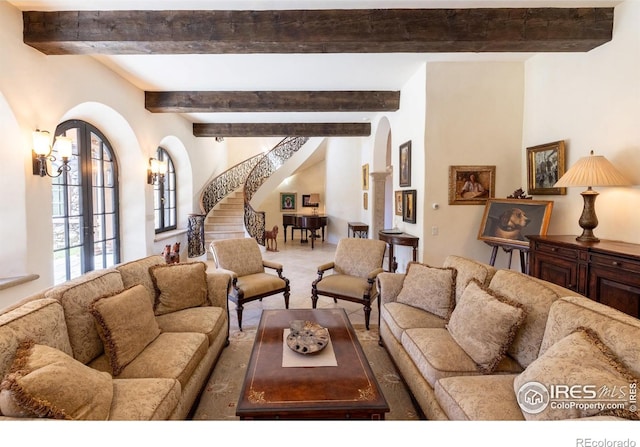 9200 Old Flowers Rd, Bellvue, CO 80512 - carpeted living area with arched walkways, stairway, and beamed ceiling