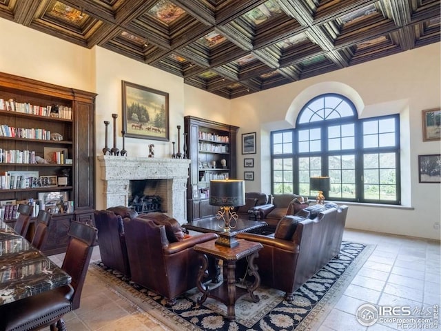 9200 Old Flowers Rd, Bellvue, CO 80512 - living area with a stone fireplace, coffered ceiling, and a towering ceiling