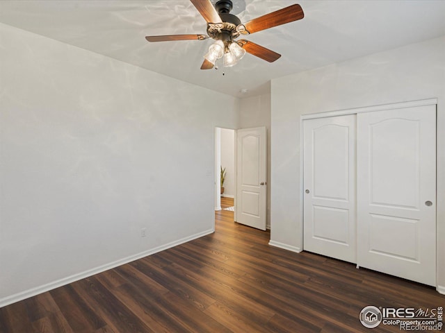 unfurnished bedroom featuring ceiling fan, dark hardwood / wood-style flooring, and a closet