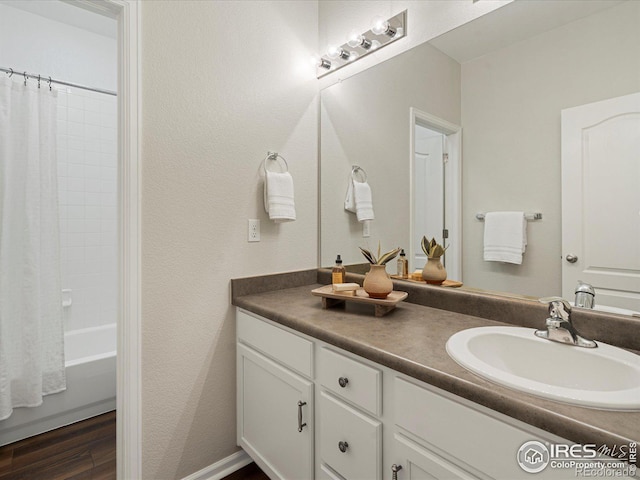 bathroom featuring vanity, hardwood / wood-style flooring, and shower / bath combination with curtain