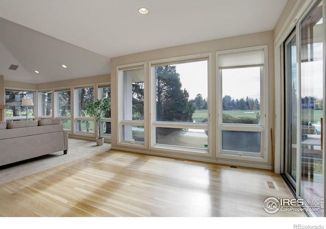 interior space featuring vaulted ceiling and plenty of natural light